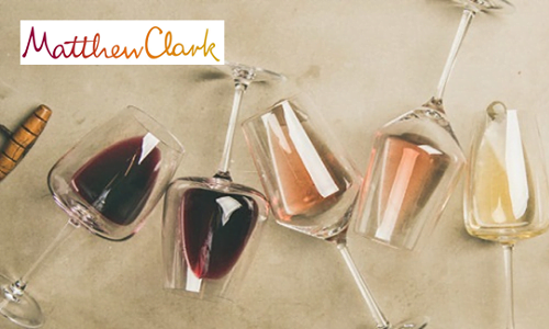 Wine glasses on their sides with, rose, white & red wine in them